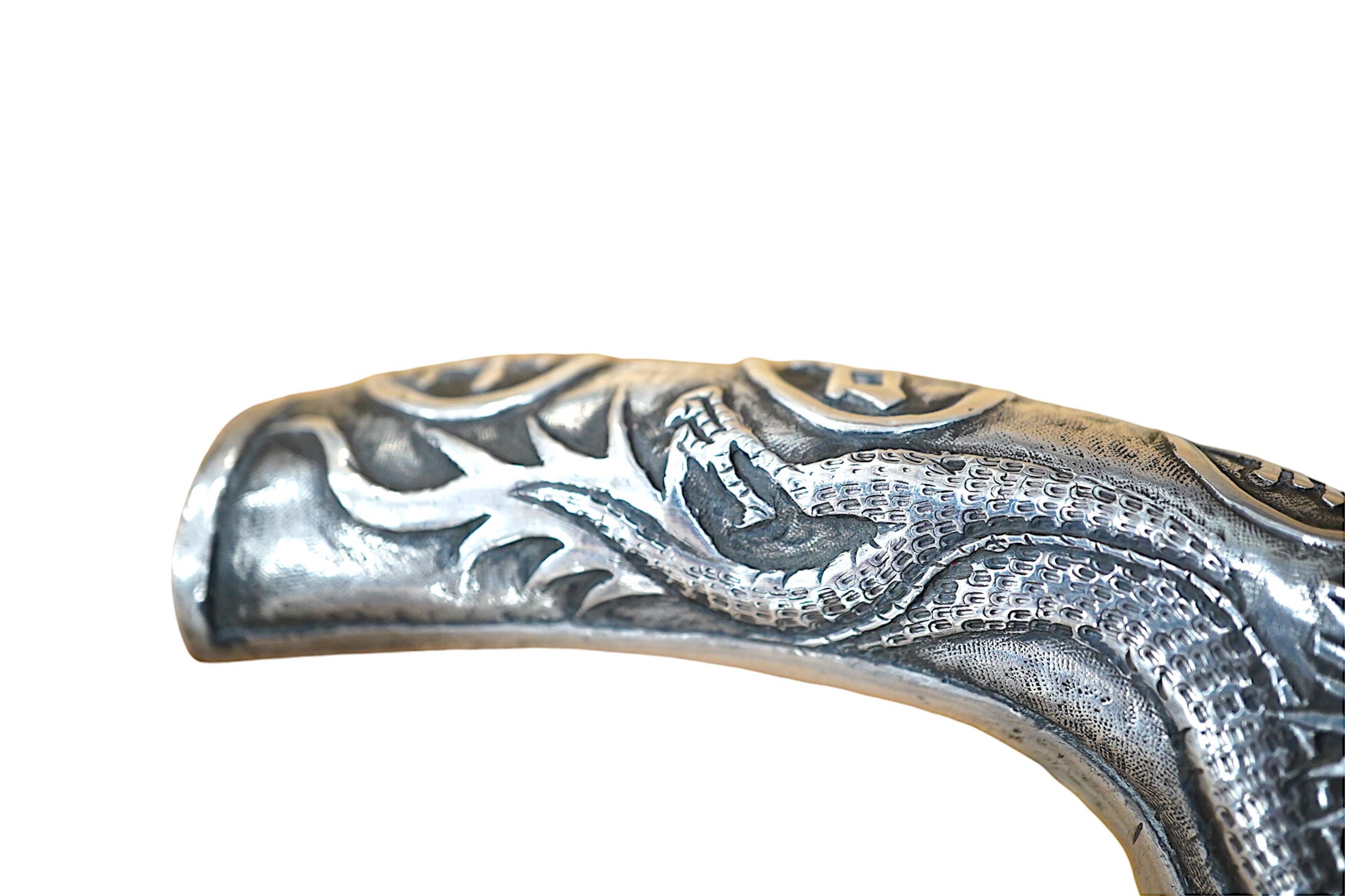 A 19th century Chinese export silver ‘dragon’ handled carved ebony walking cane, handle signed, 81cm long. Condition - fair to good